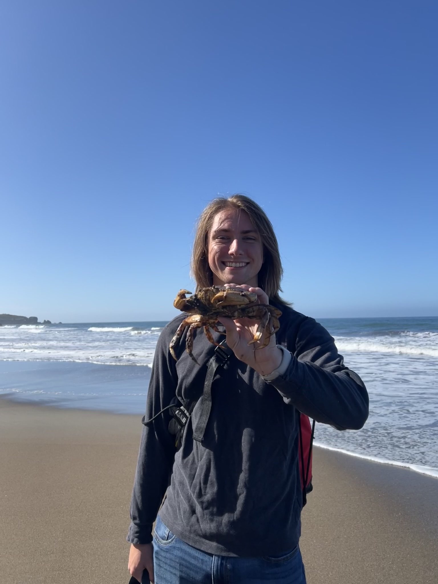 Sean with a crab he found at Stinson Beach